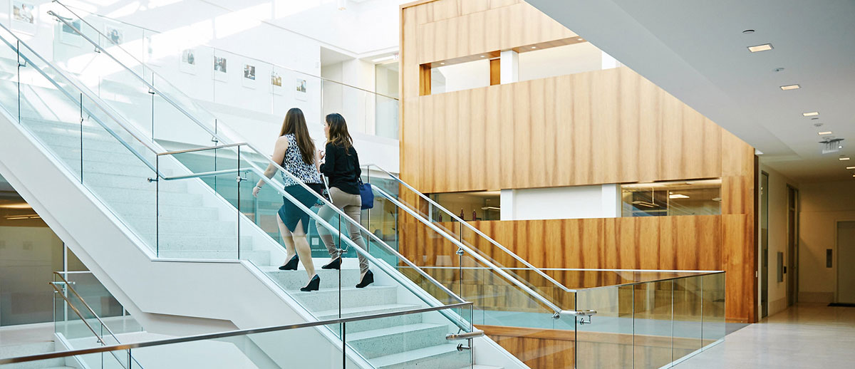 Two students walking up a stairwell in the Von der Ahe Building