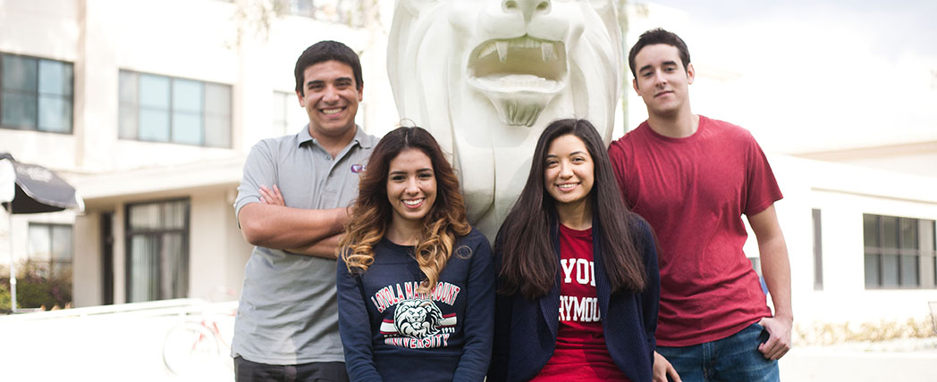 A group of students standing near the LMU Lion statue