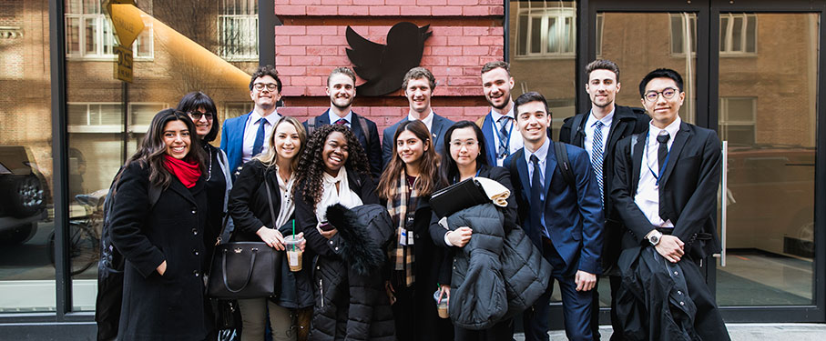A group of students dressed in professional attire outside of Twitter headquarters