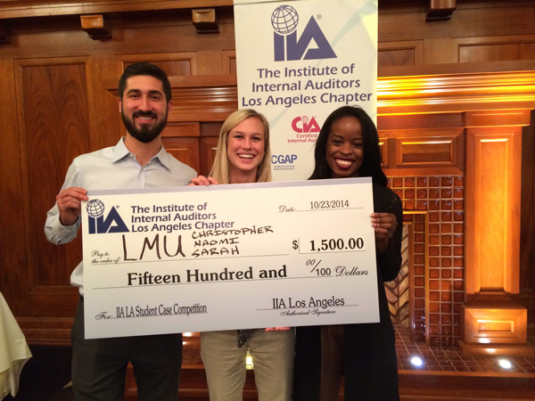 LMU MS in Accounting Students holding up their check for coming 1st place in IACSC